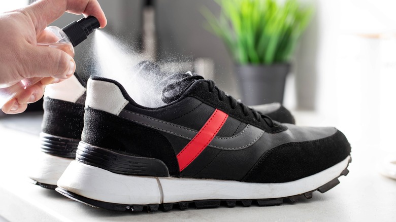 spraying shoe with spray bottle