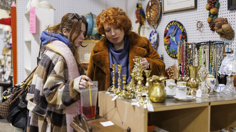 Two people shopping for decor at the thrift store