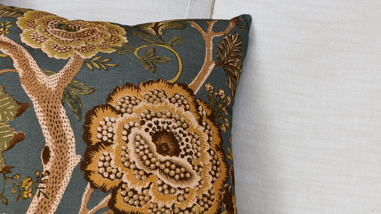 throw pillow made with embroidery material on plain sofa