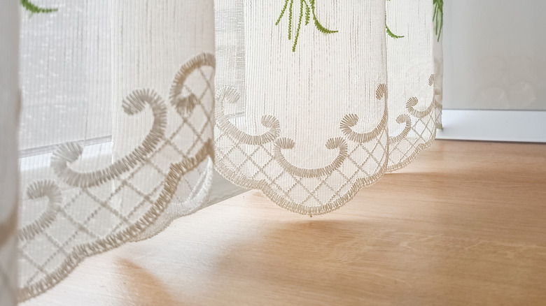 white sheer curtain with embroidery in home