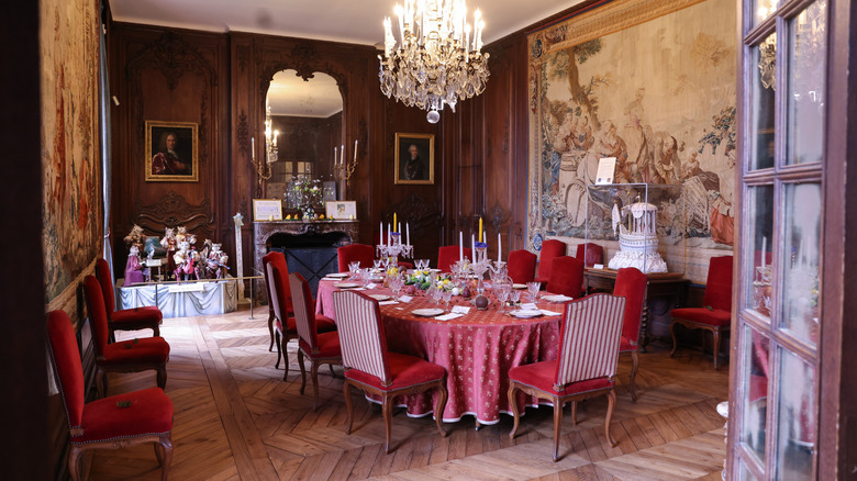 Vintage 1900s home interior with a red dining table