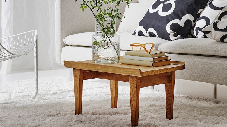 Small wood coffee table in a white room