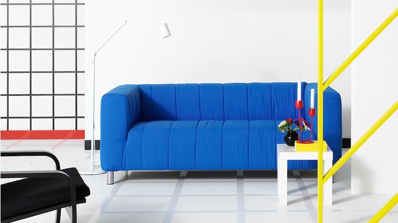 Bright blue sofa in a white room