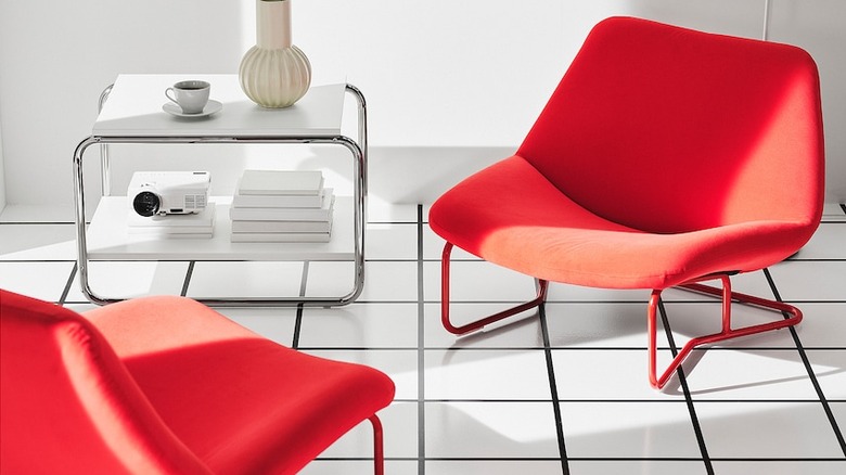 Bright red armchairs in a white room