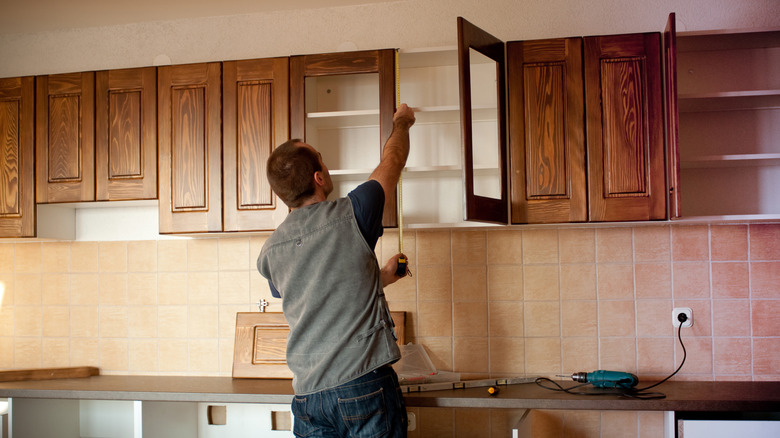 person working on new kitchen cabinets