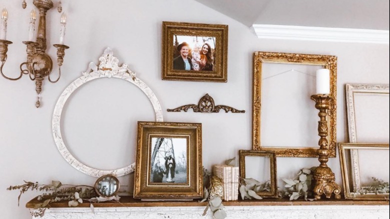 Gold frames assembled on a mantel