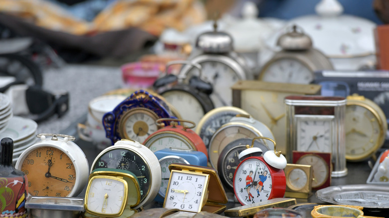 A bunch of different clocks at a thrift store