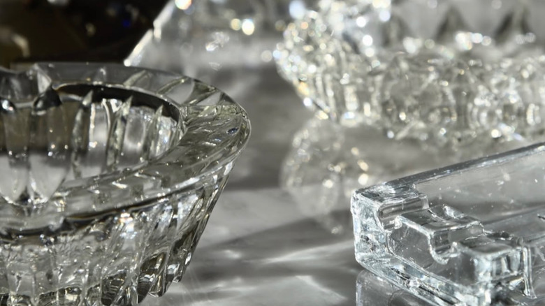 A collection of clear glass ashtrays