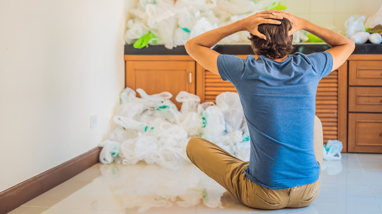 Someone frustrated with all the plastic bags in their kitchen