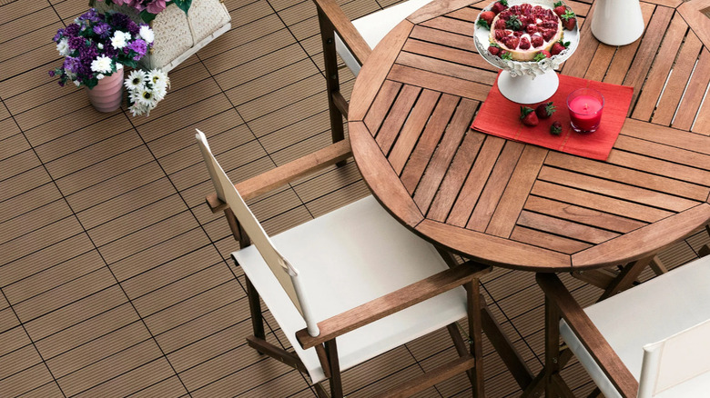 A patio set sitting on top of the Golden Select Deck Tiles