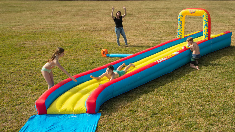 A family enjoys the Wham-O slip 'n slide
