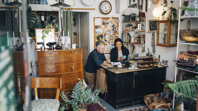 Workers behind desk in antique shop