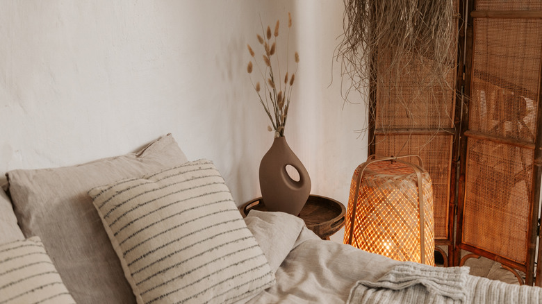 A wabi sabi bedroom is decorated in white with natural fiber accents.