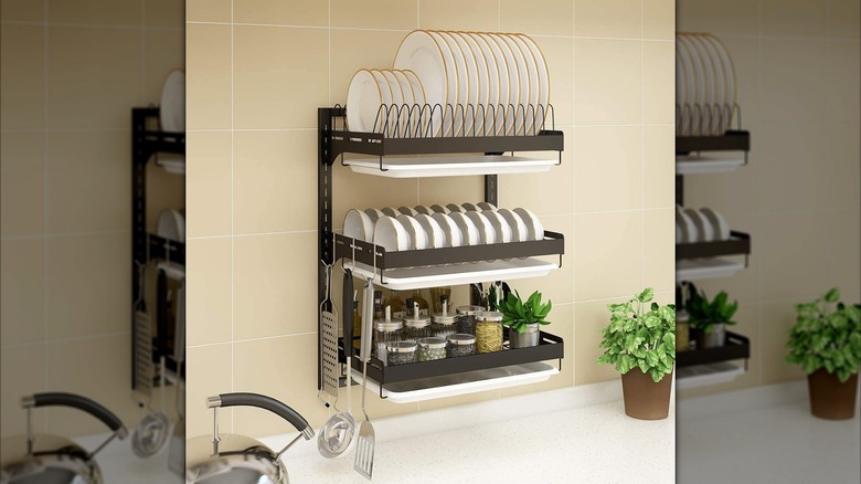 Wall mounted dish rack with plates, bowls and utensils
