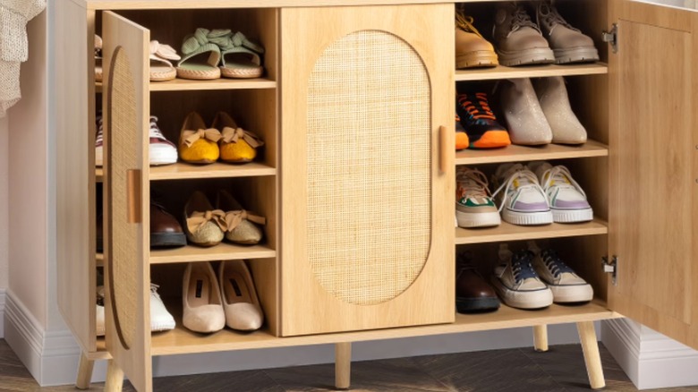 A rattan Ktaxon cabinet from Walmart stores shoes in a home.
