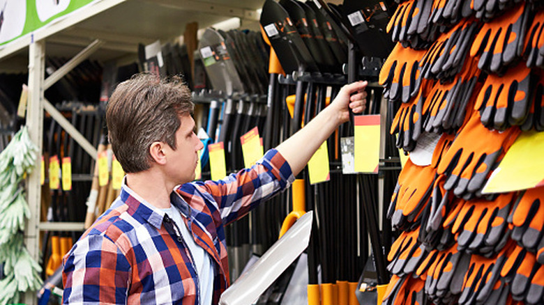 Man considering shovels