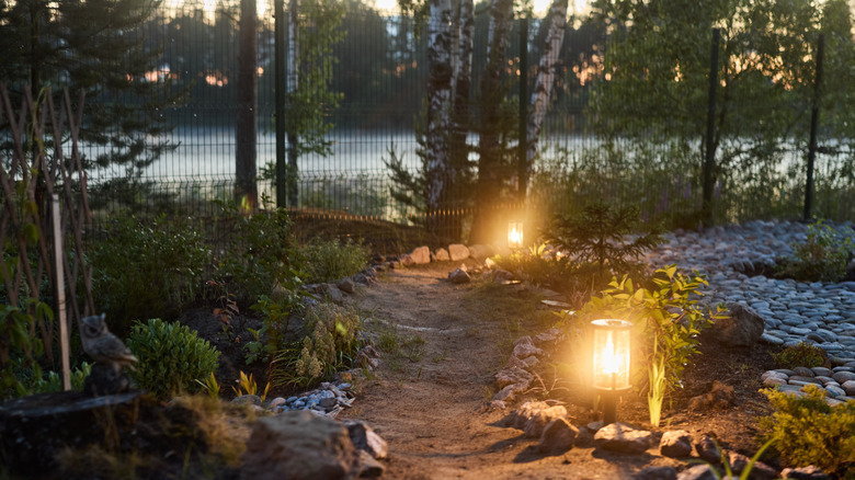 garden walkway illuminated by lanterns