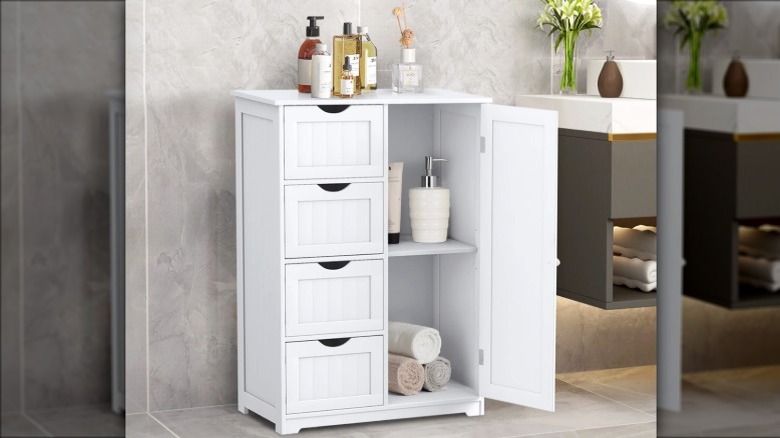 A white storage cabinet in a bathroom with beauty supplies