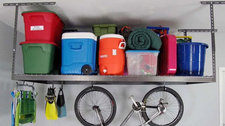 Overhead garage storage rack with a bike hanging underneath