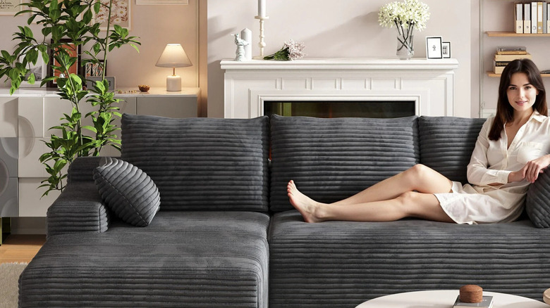 A woman lounges on a grey IDEALSOUL Cloud Sectional Couch
