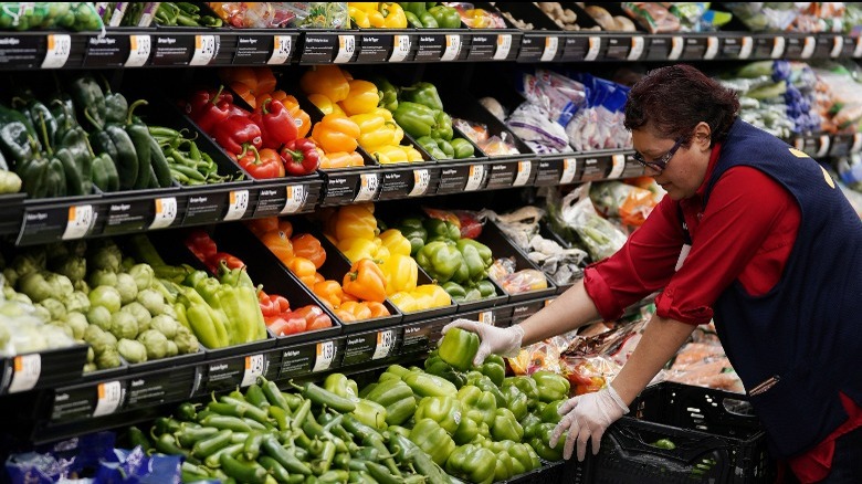 Woman stocking produce