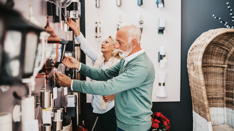Older couple looking for an outdoor lantern at the store