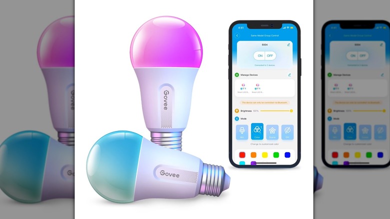 Govee lightbulbs next to a phone showing the Govee app