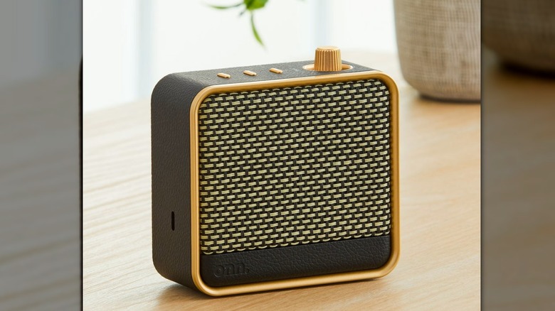 onn speaker on a table with plant behind