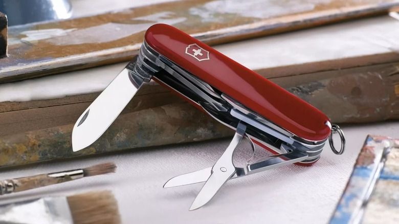 Victorinox knife on a table with painting supplies
