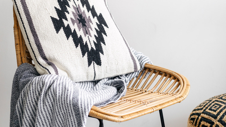 Rattan chair with pillow and throw blanket