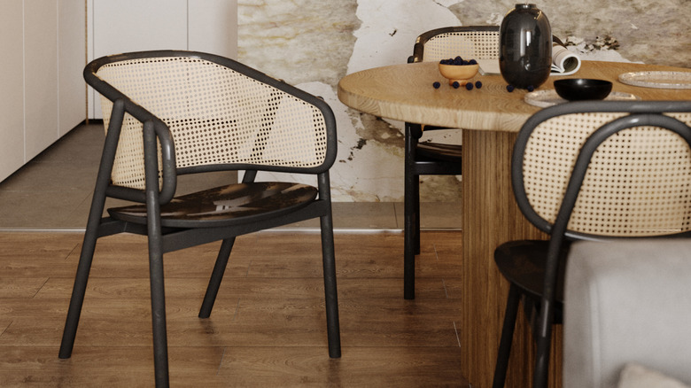 Rattan chairs at a wooden dining table