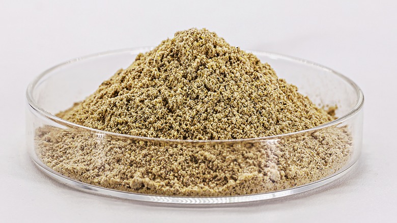 Close up of bone meal ground in glass bowl