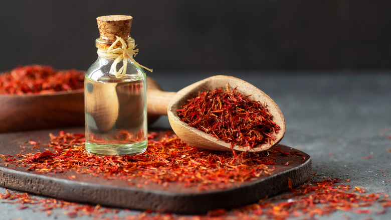 Dried saffron and a bottle of oil