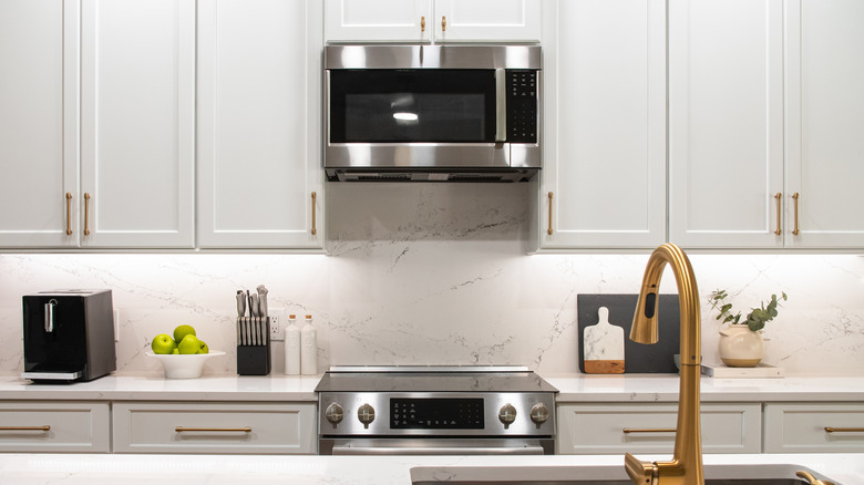 An over the range microwave in new, white kitchen