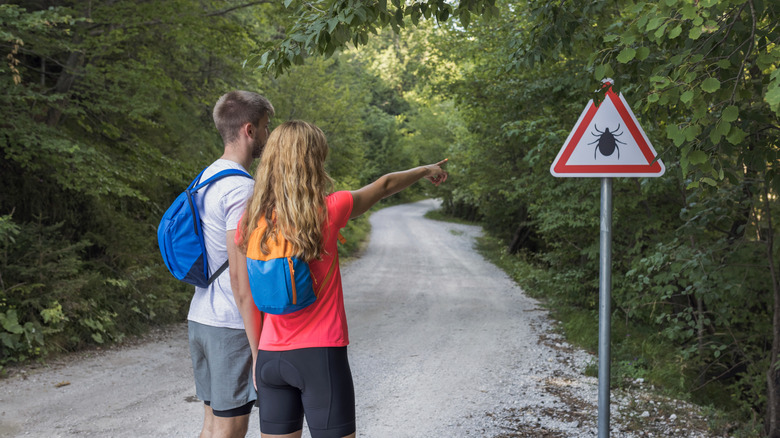 Hikers notice tick warning sign