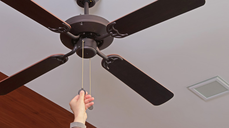 Person turns on ceiling fan to warm up their basement.