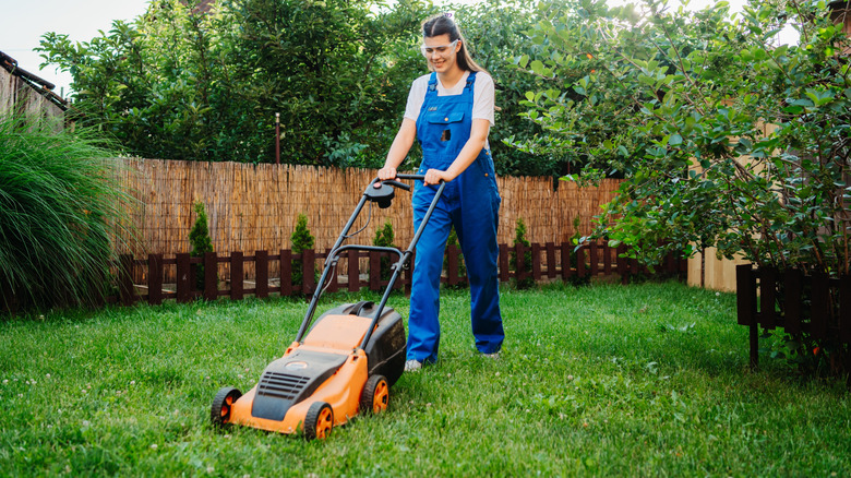 Woman mowing lawn