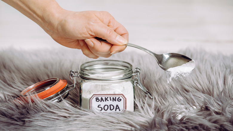 Person sprinkling baking soda