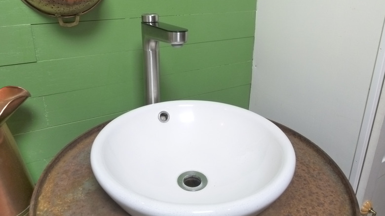 The X12 Pro faucet installed atop a rusty 55-gallon drum