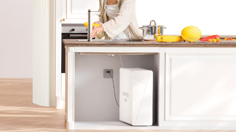 A white Waterdrop filtration system under a sink