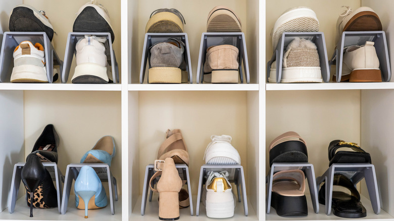 Shoes in shoe slots on shelves