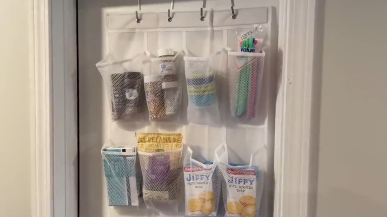 Shoe holder on a pantry door containing boxes, pouches, and bags of food and ingredients