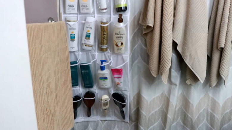Over-the-door shoe holder attached to a shower curtain rod holding bathroom essentials