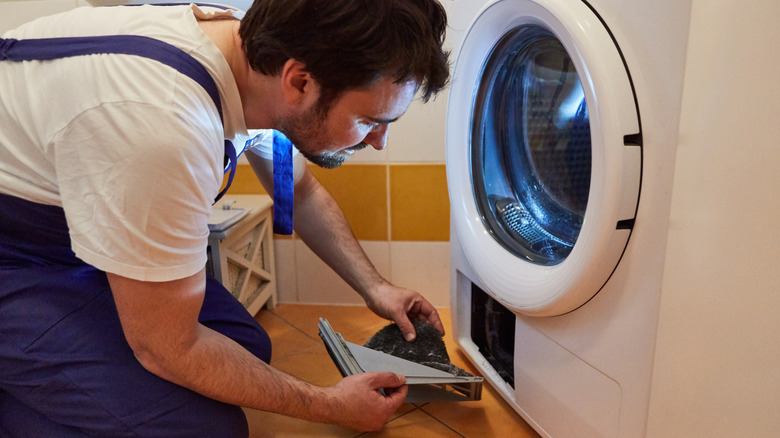 Man cleaning out lint trap