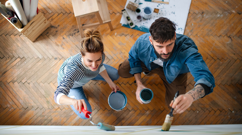 couple painting a wall