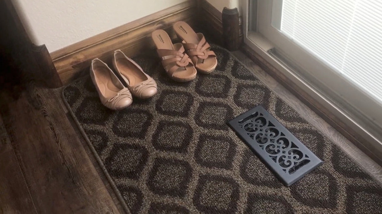 A doormat or rug with a cutout to fit a floorvent