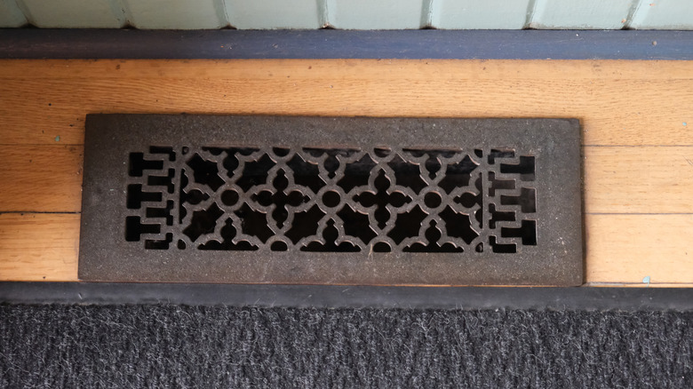 A decorative metal floor vent cover
