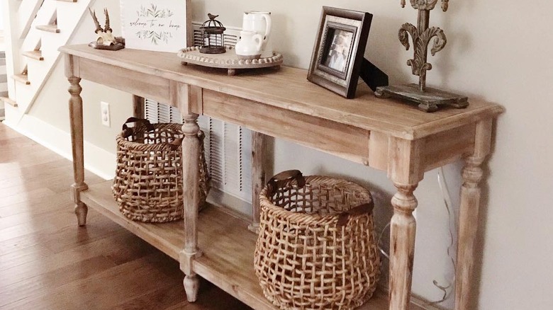 A console table placed in front of an air vent