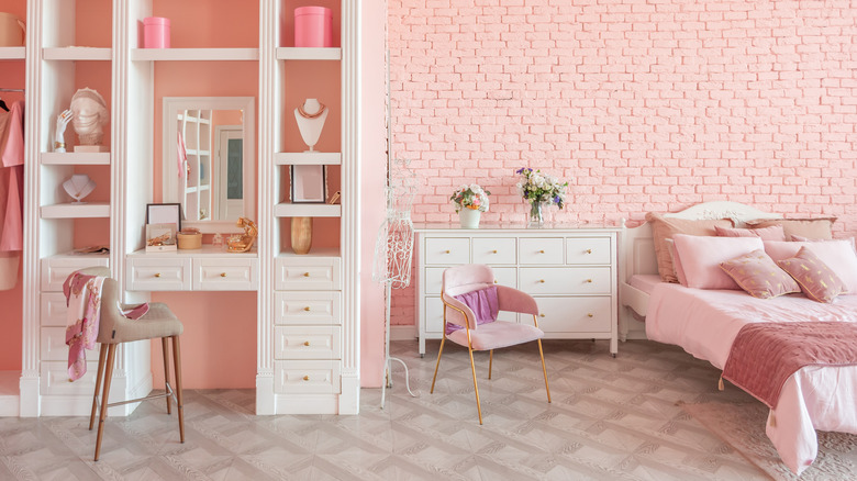 pink bedroom with bed and chairs