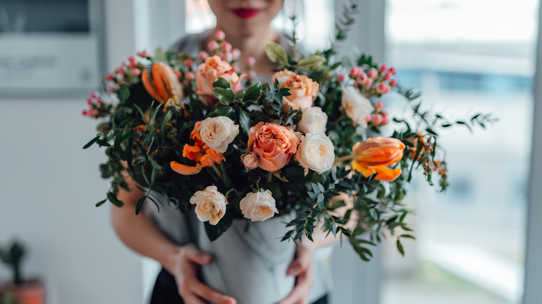 Woman holding roses indoors
